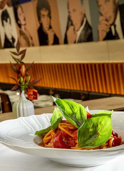 Pasta in front of artwork by Andy Warhol at Casa Lever.