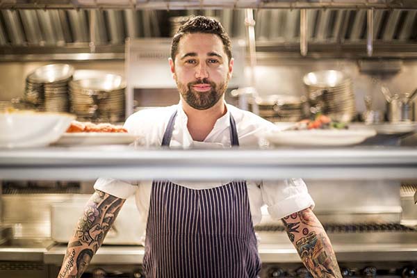 Chef Sal Lamboglia posing for a portrait in the kitchen at his restaurant Bar Primi.