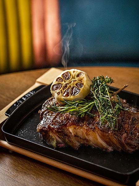 A steak sizzling waiting to be eaten at Feroce.