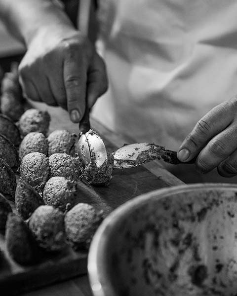 Closeup of hands making gnocchi in the kitchen.
