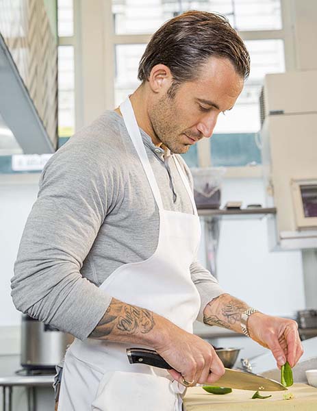Chef Michael Chernow preparing food in the kitchen at his restaurant Seamore's.