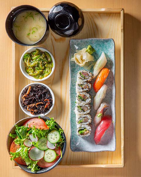 A bento box from the Japanese restaurant Morimoto artfully arranged on a tray.