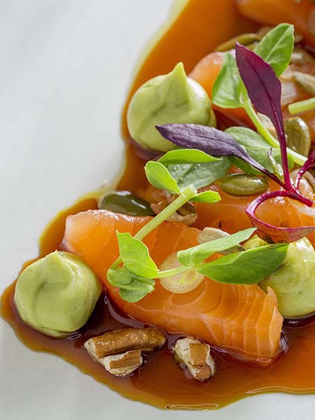 A close up photograph of artfully plated food at the restaurant Perry St.