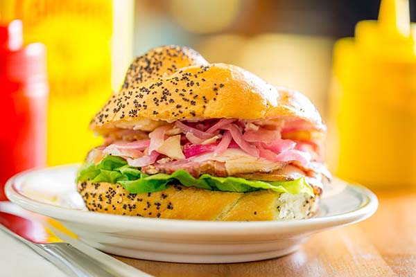 A deli sandwich floating on a plate at White Gold Butchers
